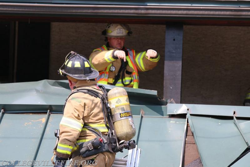 Peeling back the steel roof to check for extension.